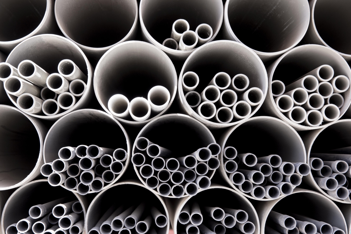 many pvc pipes are stacked together in a row