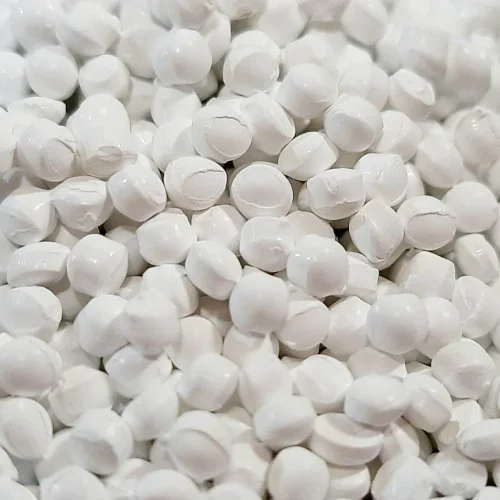 A heap of white plastic balls, known as White Masterbatch, used in various industries for coloring plastic products